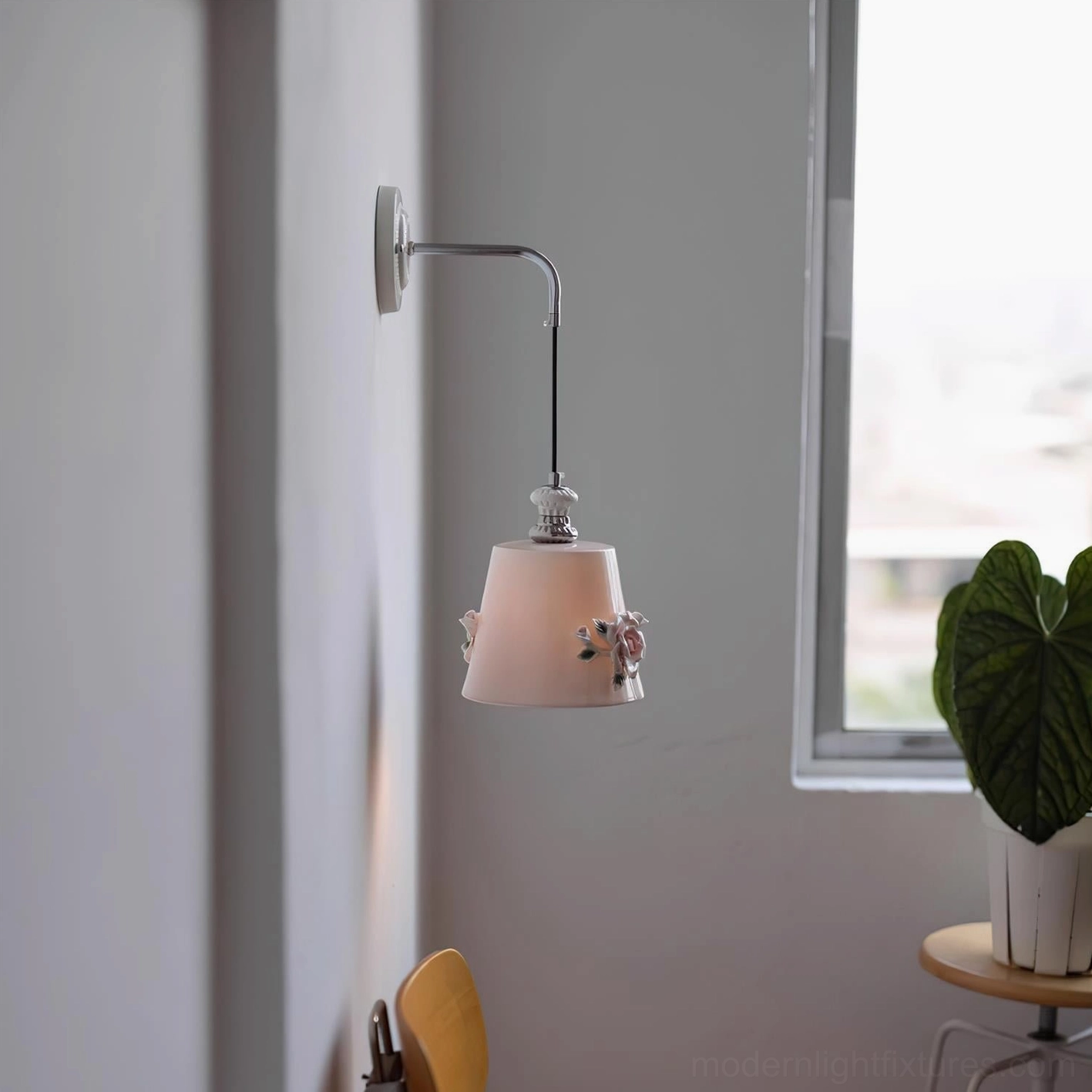 Small compact ceramic wall lamp Roselune Model D with matte pink flower decor shade in Nordic home setting near window