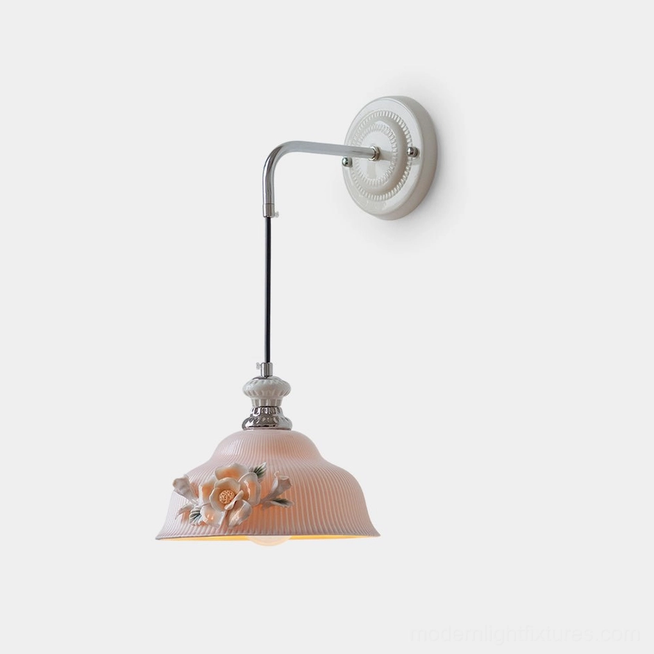 Roselune ceramic wall sconce with hand-sculpted pink floral shade and polished chrome metal arm, front view studio lighting