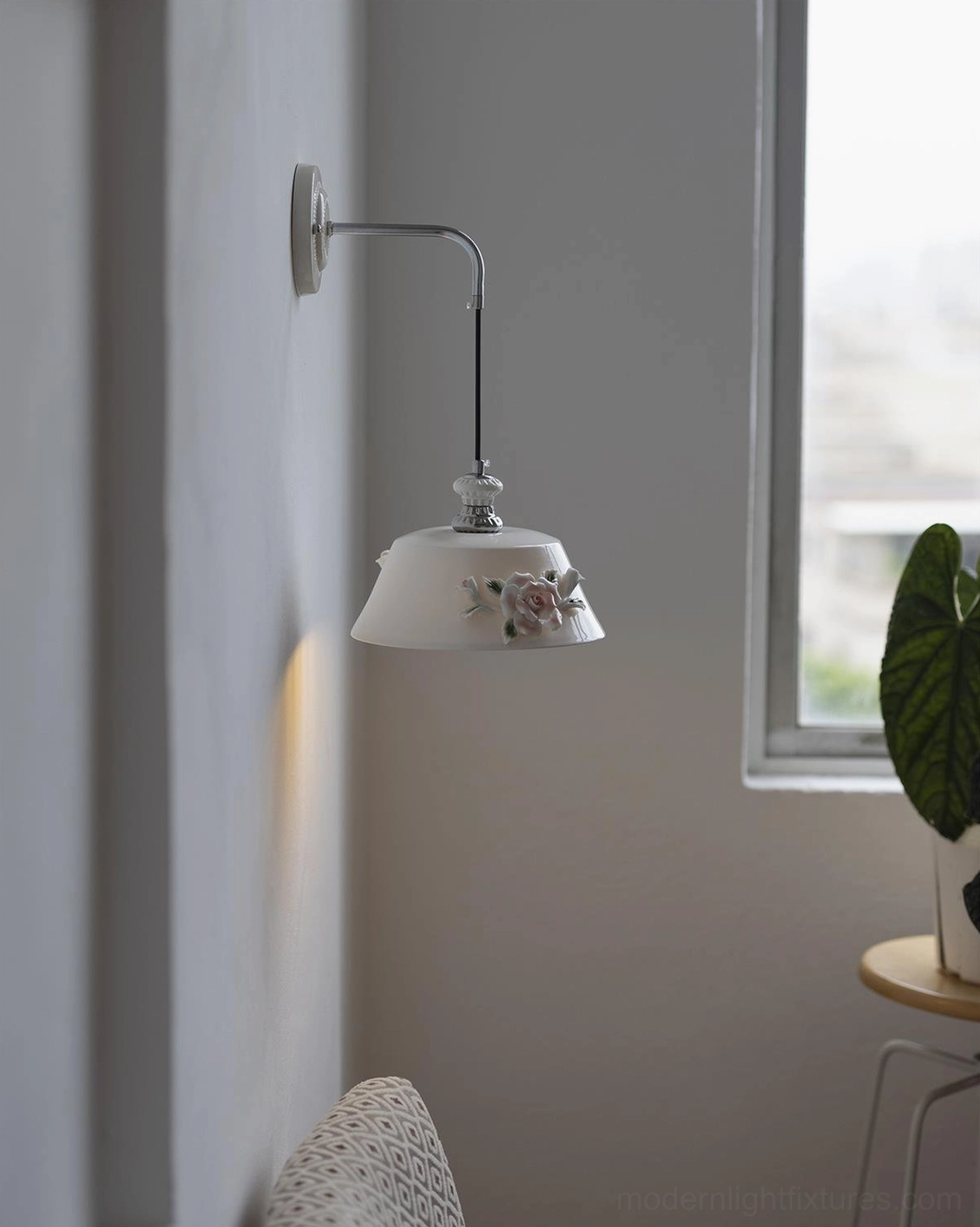 White ceramic wall sconce Roselune with hand-sculpted floral relief and polished chrome bracket in minimalist living space