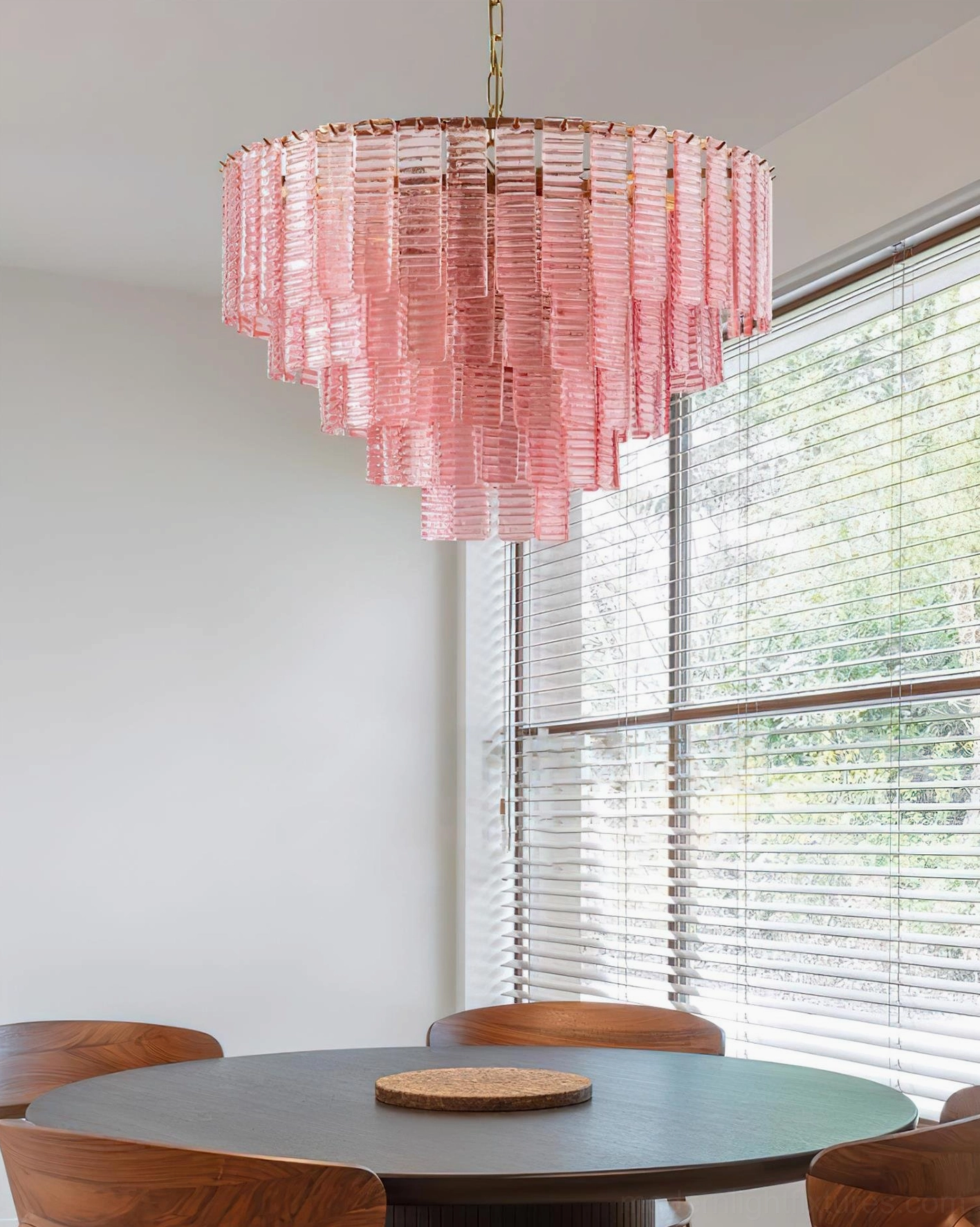 Rosewater tiered glass chandelier interior view - cascading pink glass tiers above wooden dining table with ambient window lighting