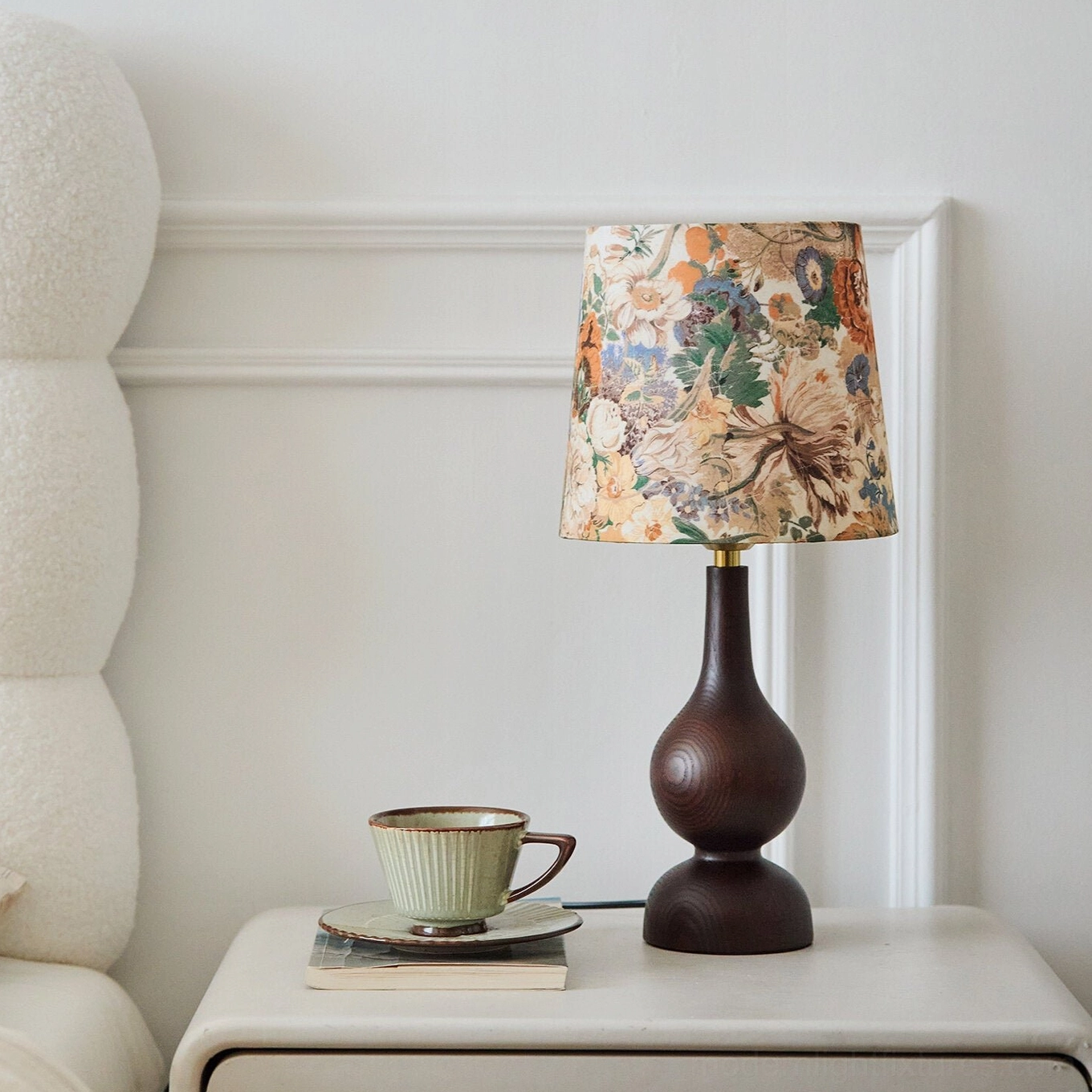 Ash wood gourd-base table lamp with floral fabric shade on living room bedside table, warm light ambiance