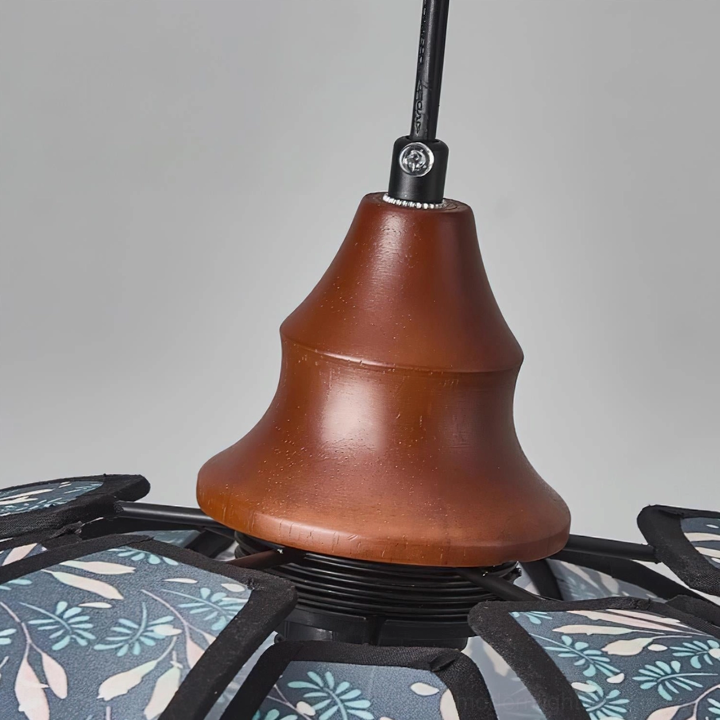 Rosmira floral pendant light warm glow effect, showing shadow and light interplay on walls and ceiling with fabric shade