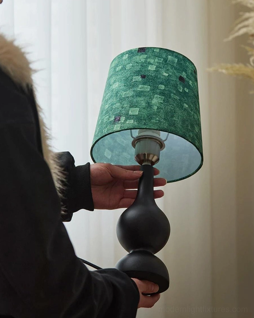Rosmira table lamp being assembled, showing green checkered shade and ash wood base construction details