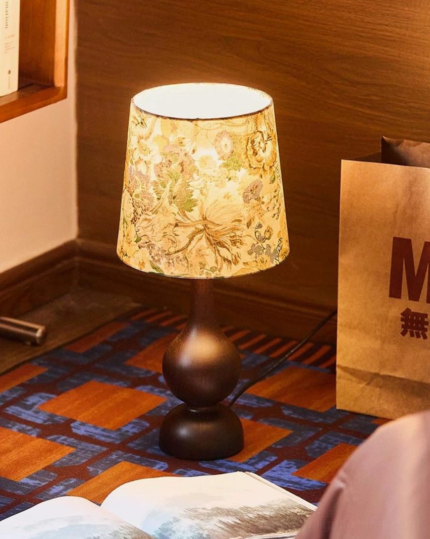 Table lamp fabric shade texture detail showing floral print pattern and weave, warm light diffusion