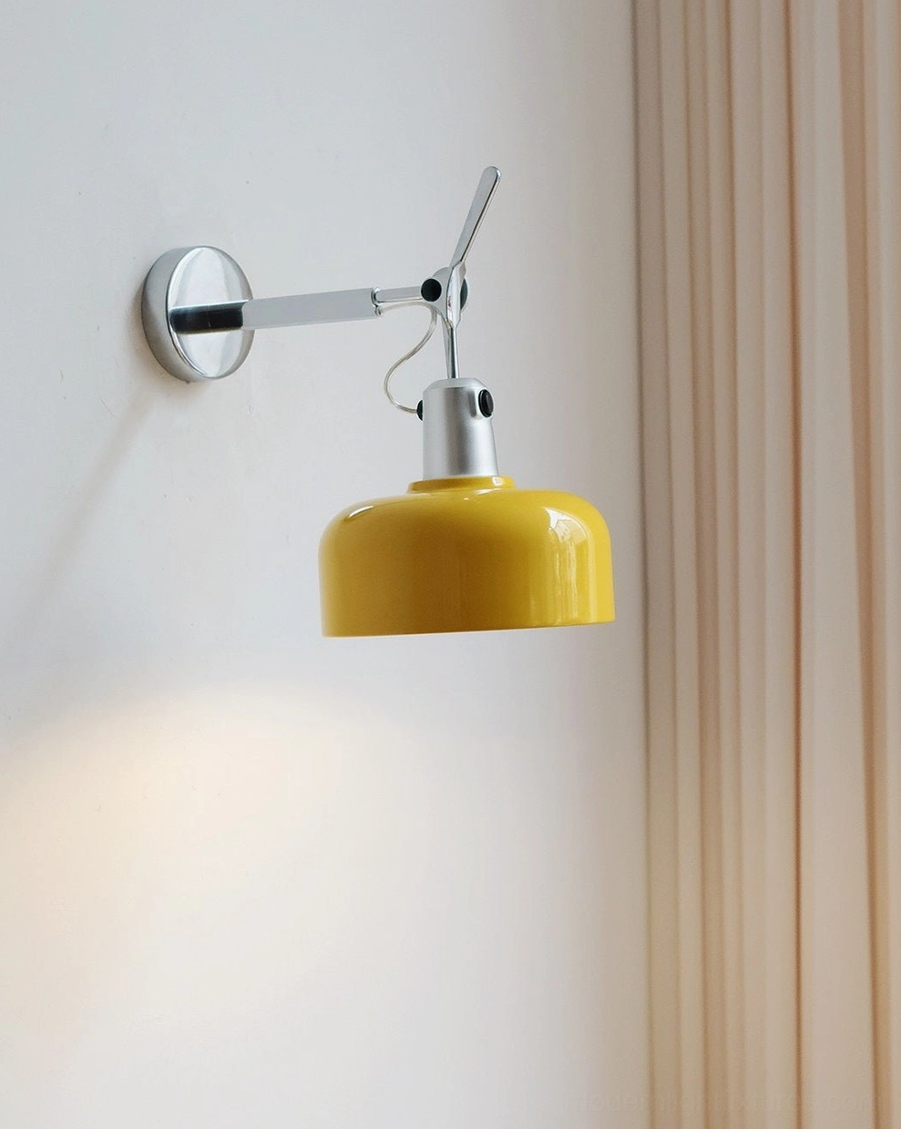 Rosso adjustable mid-century wall sconce with yellow aluminum drum shade and chrome arm, studio front view