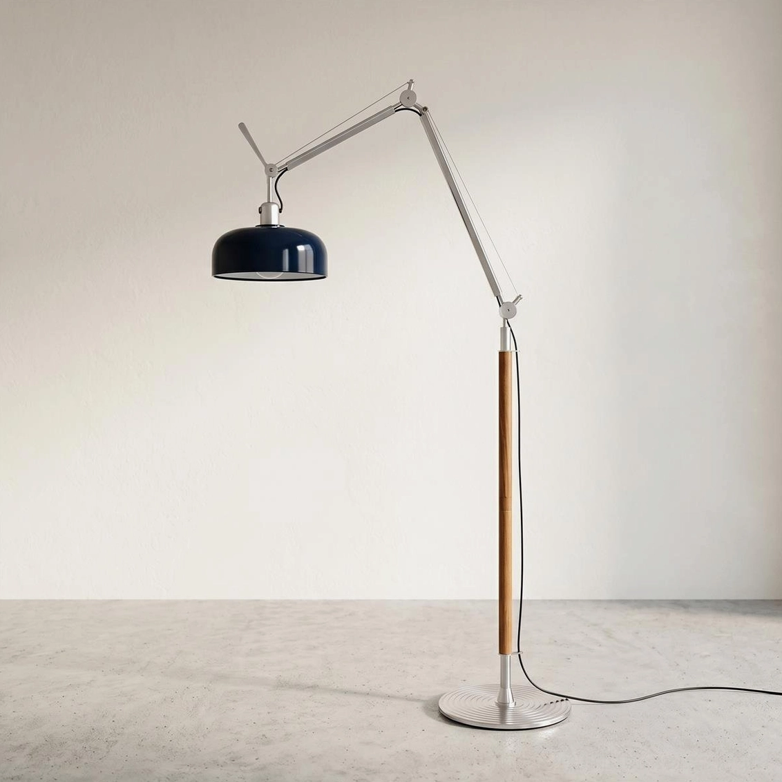 Rosso articulating floor lamp with navy blue dome shade on minimalist concrete floor background