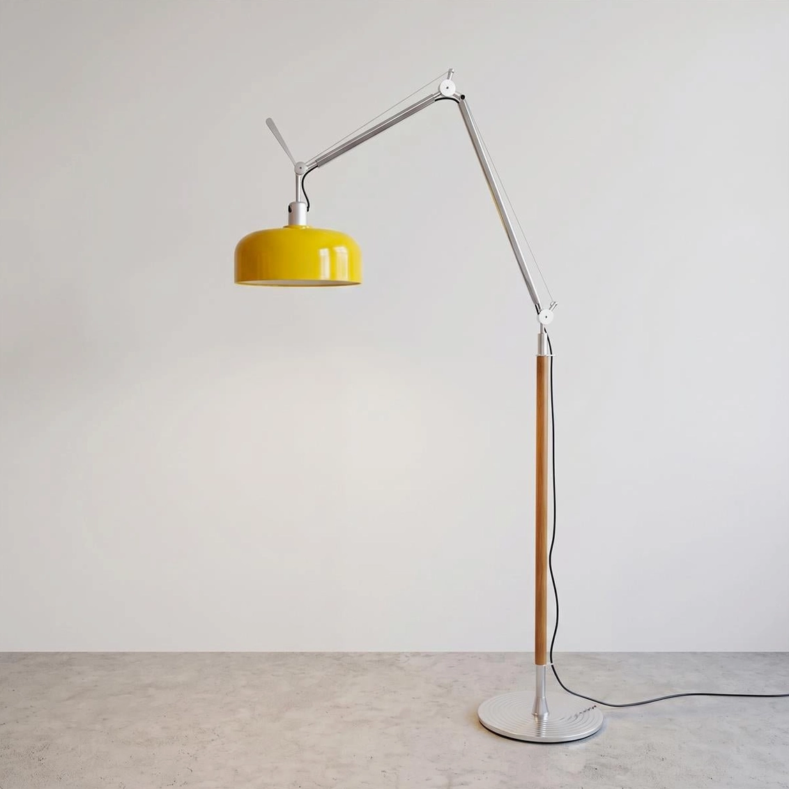 Rosso floor lamp with yellow dome shade and extended articulating arm on neutral minimalist background