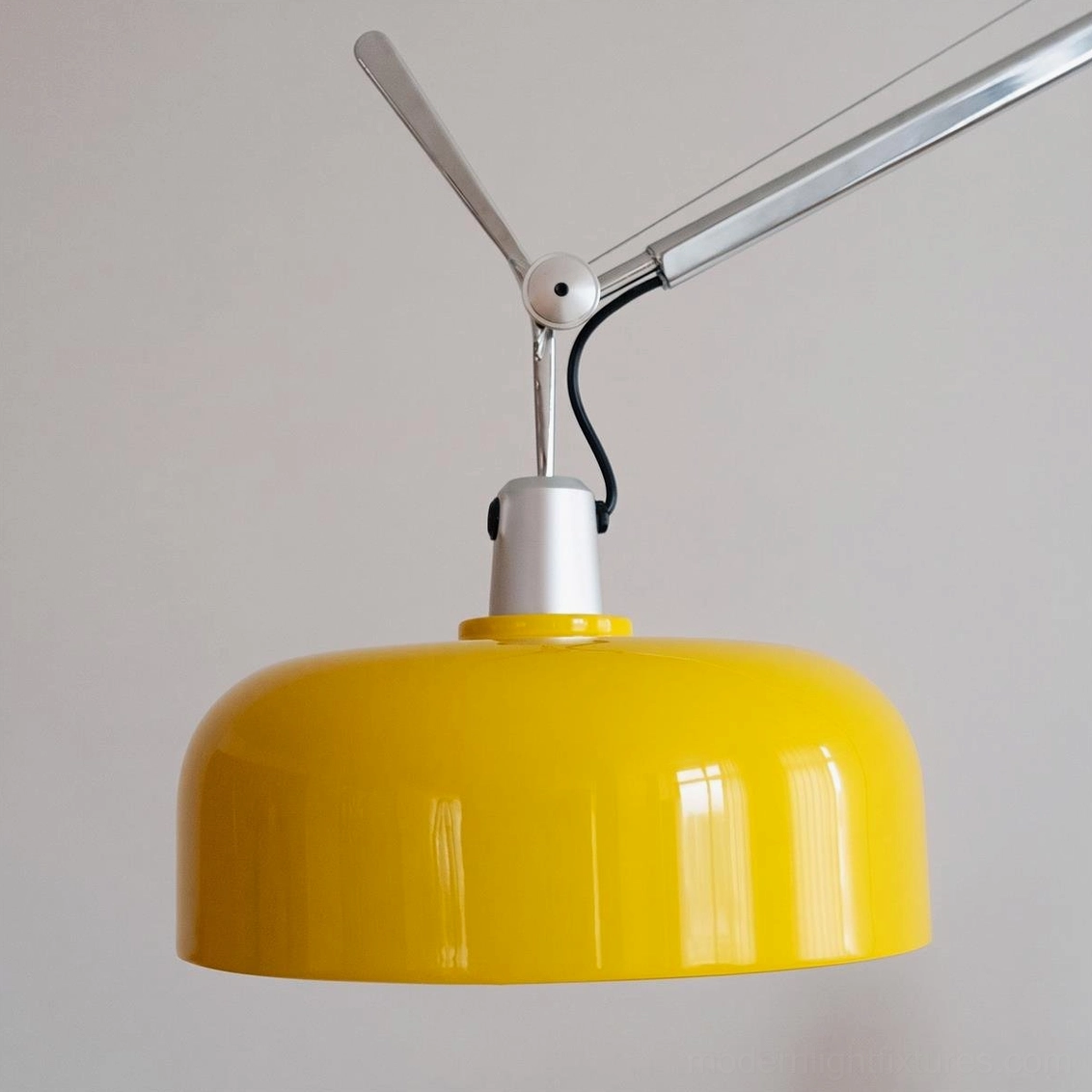 Rosso floor lamp with yellow dome shade and exposed power cord routed along minimalist studio corner