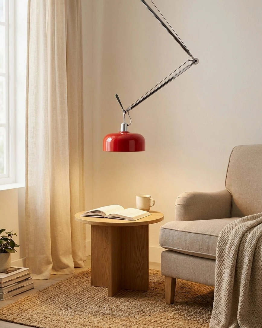 Red articulating pendant light in minimalist living room with warm neutral decor