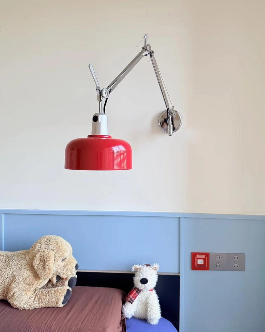 Vermillion red swing arm wall sconce on light blue bedroom accent wall, mid-century modern lighting design