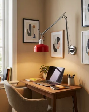 Rosso swing arm sconce mounted above wooden study desk in home office, demonstrating functional task lighting for workspace