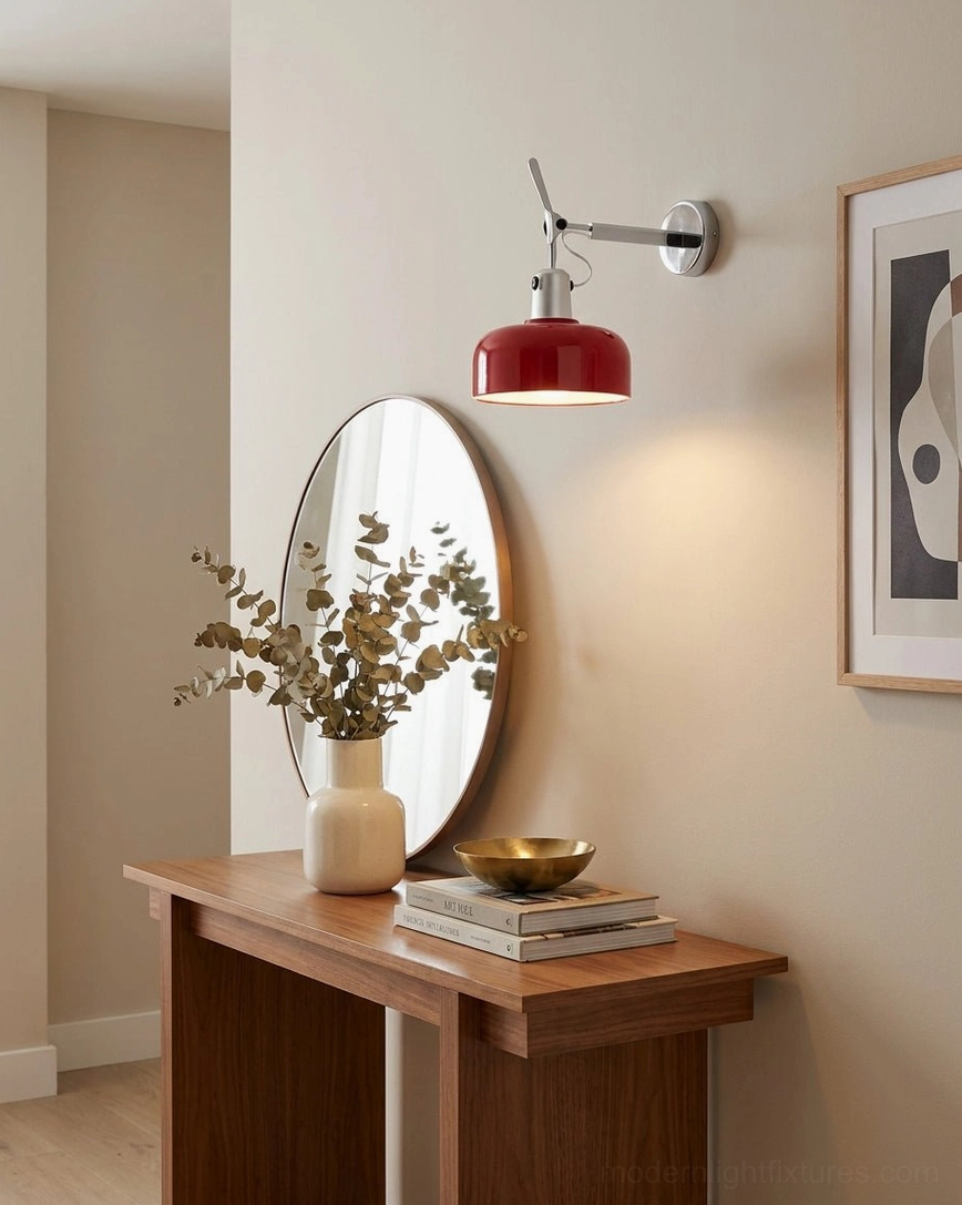 Red Rosso task sconce mounted above bedroom vanity with round mirror and console table
