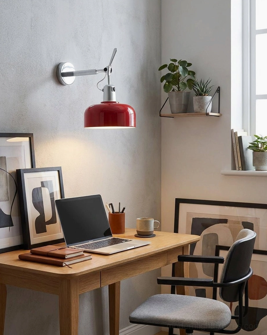 Adjustable red Rosso sconce in home office workspace mounted on grey wall with wooden desk