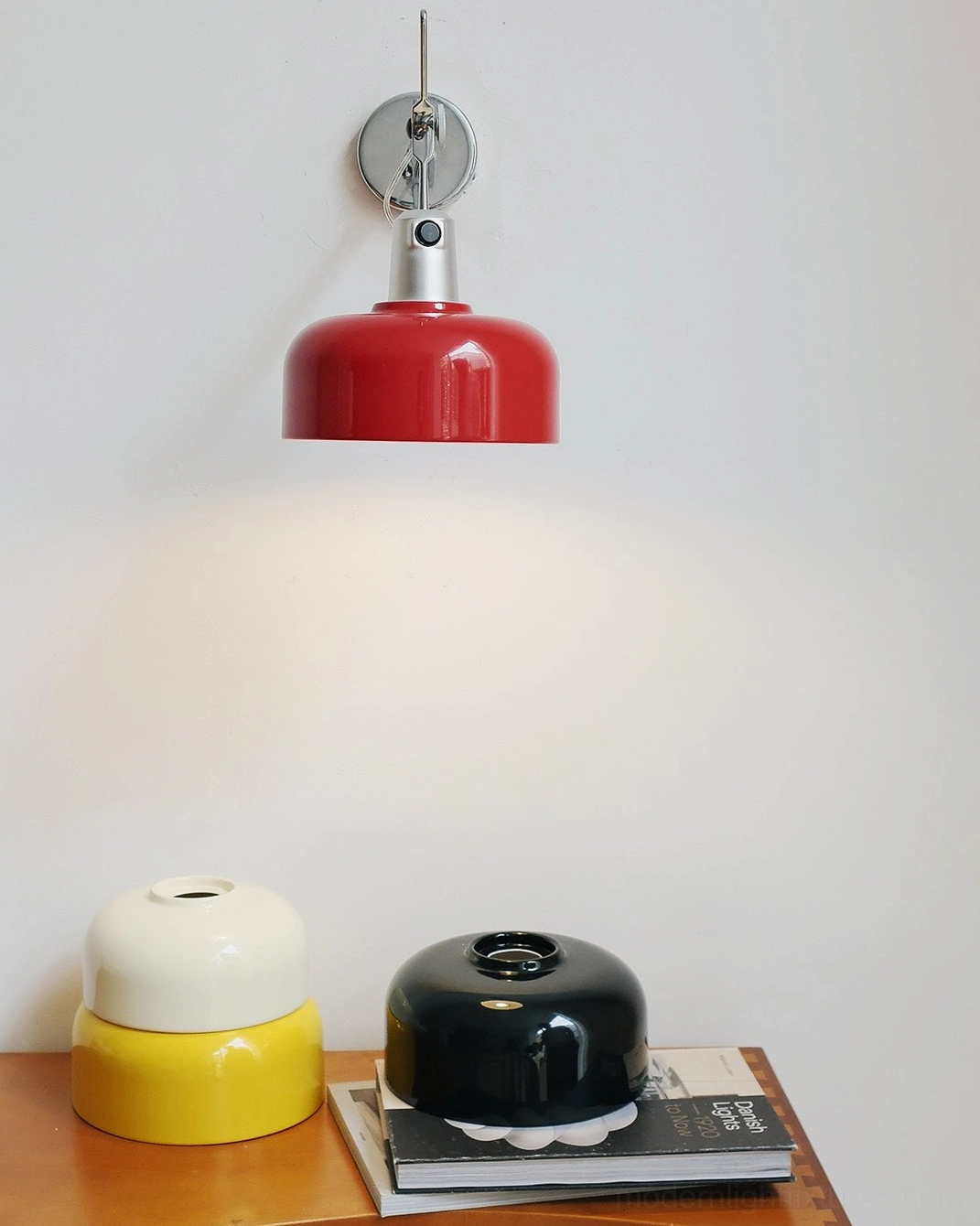 Red Rosso wall sconce close-up display with decorative tableware and styling accessories