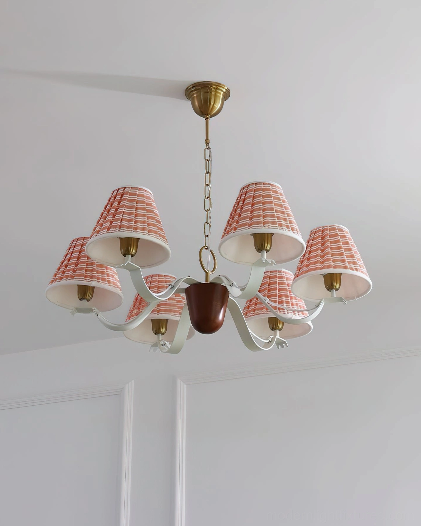 Rosvyn pleated fabric chandelier mounted above dining table creating intimate warm ambiance