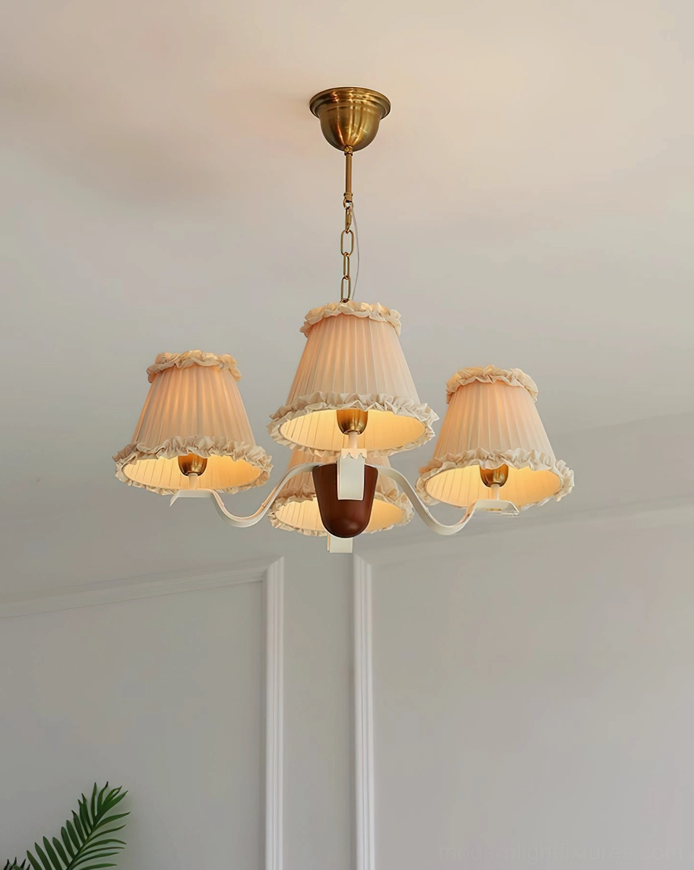 Rosvyn vintage retro pleated fabric chandelier with brass hardware glowing in minimalist neutral interior space