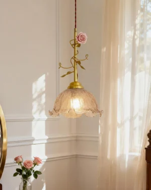 Rosy Reverie vintage brass pendant lamp with sculptural porcelain blooms illuminated in French bedroom corner with natural daylight