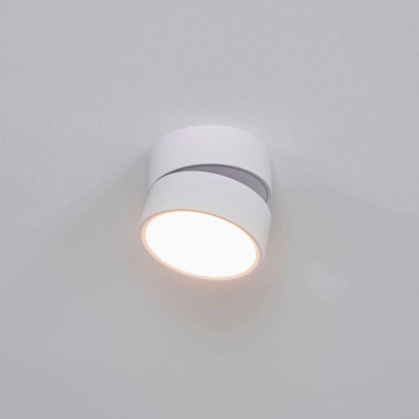 Modern rotatable ceiling fixture showing tilt and rotation capability for directional lighting control