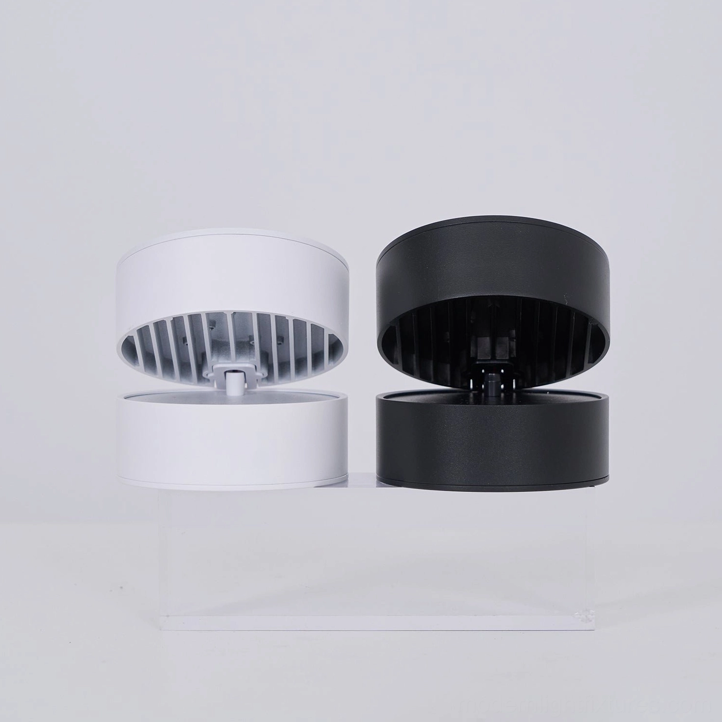 Modern rotatable ceiling light demonstrating accent lighting placement above gallery wall artwork