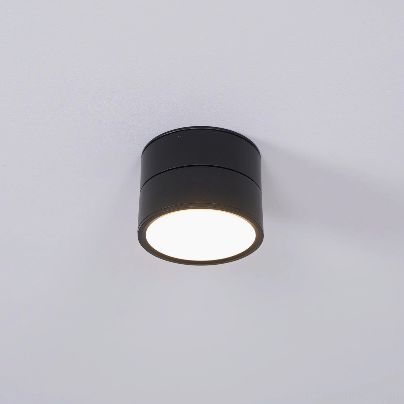 Rotatable ceiling light fixture installed as part of coordinated multi-light system in open living space