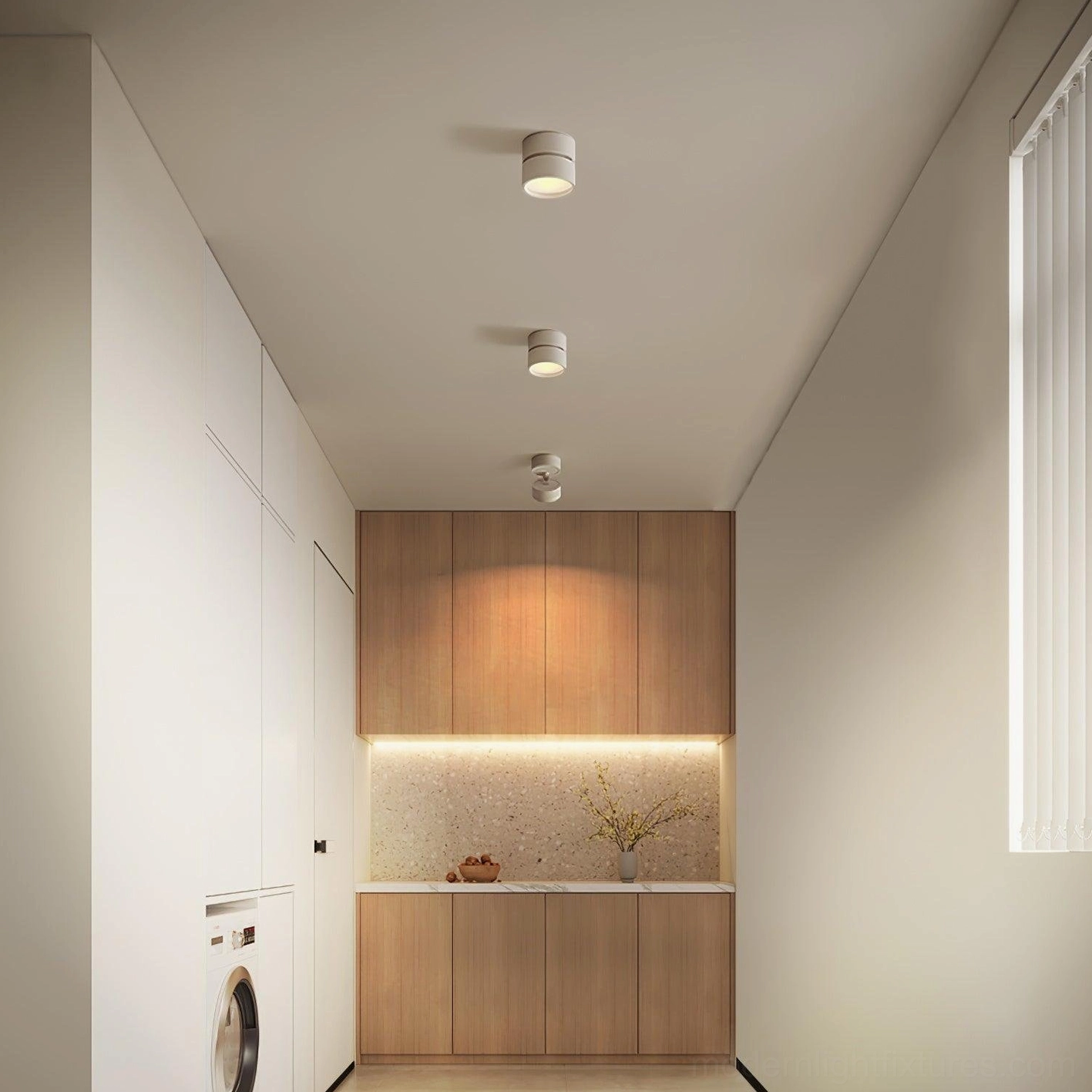 Clean white laundry corridor with flush-mount rotatable spot lights arranged for functional and architectural lighting