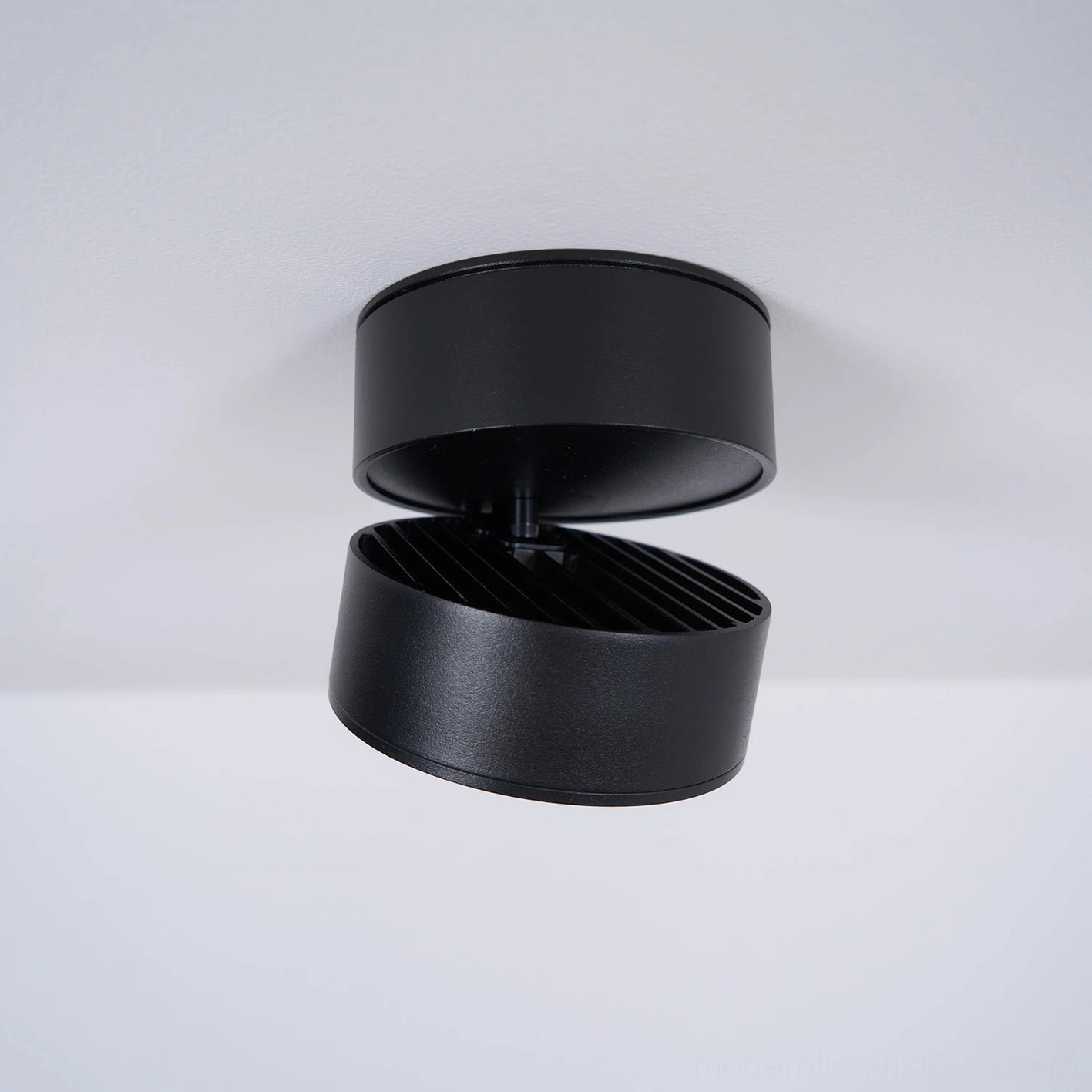 Multiple rotatable ceiling spot lights creating professional gallery-style accent lighting without track systems