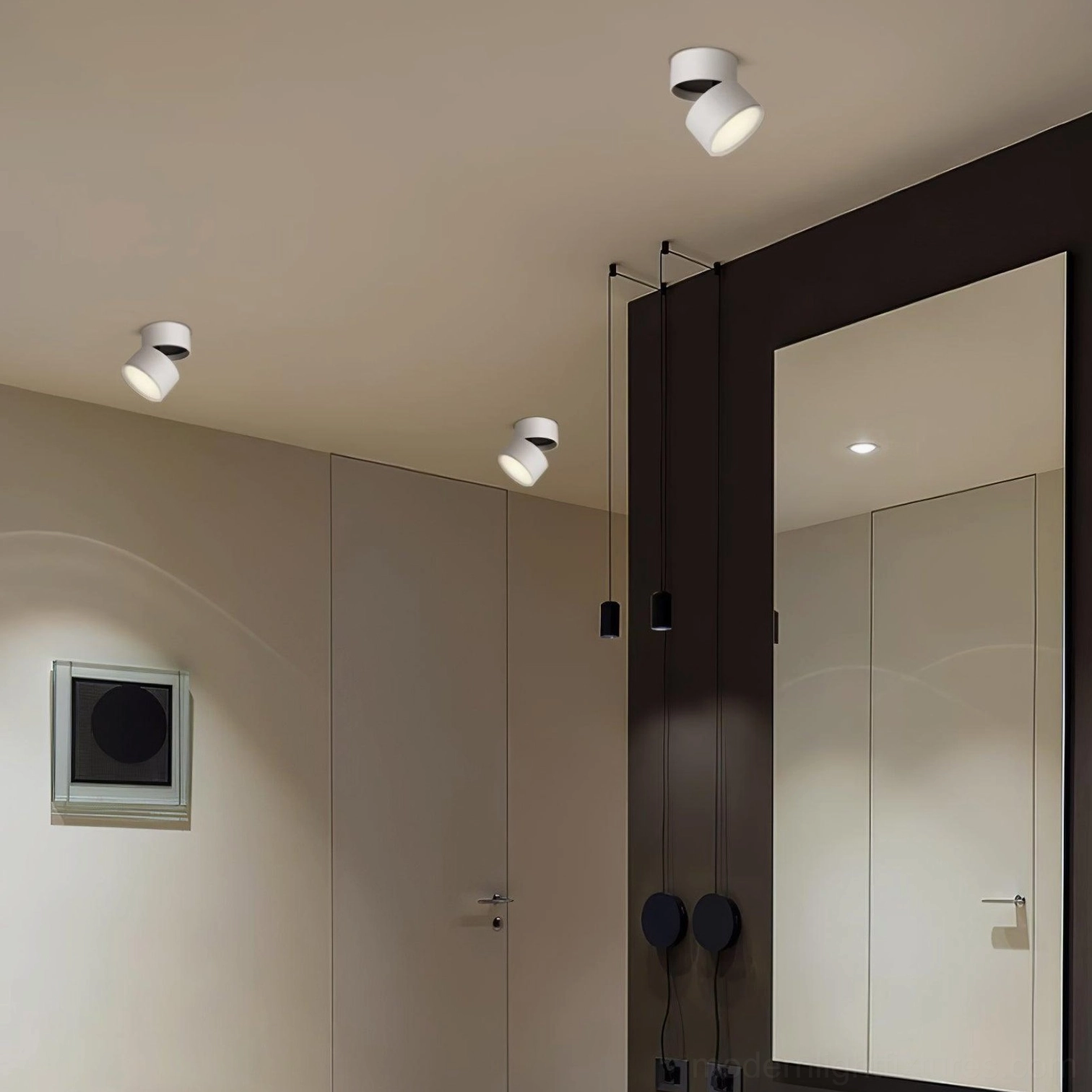 Bedroom dressing area with white rotatable surface spot lights providing adjustable directional lighting
