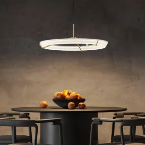 Contemporary circular ring pendant lamp with warm brass hardware in modern dining room setting