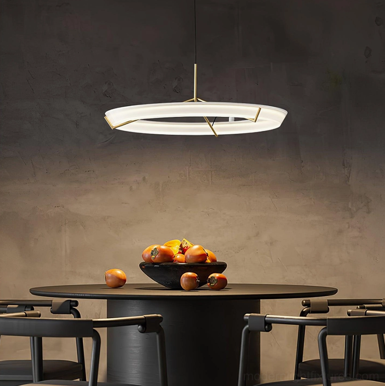 Contemporary circular ring pendant lamp with warm brass hardware in modern dining room setting