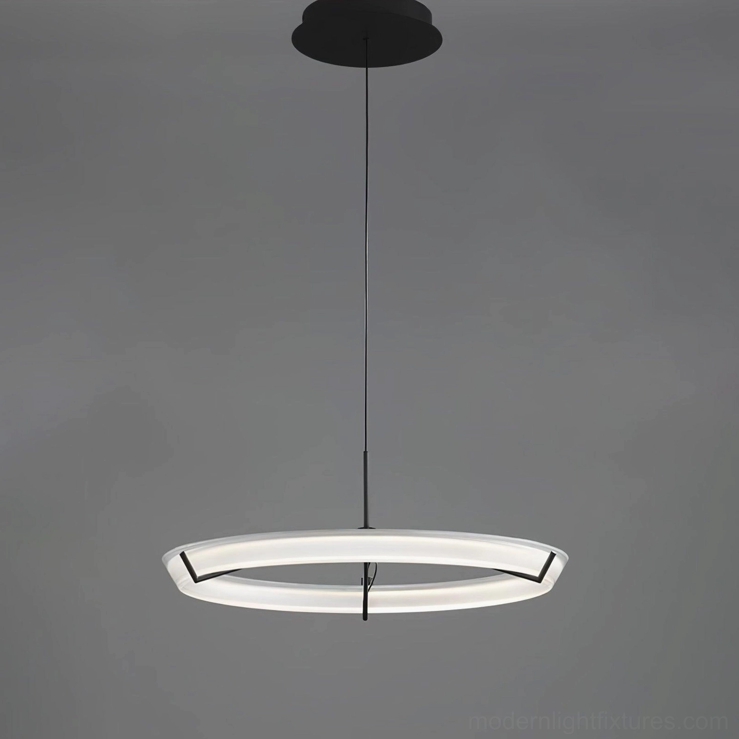 Contemporary round pendant light with acrylic diffuser creating even warm illumination