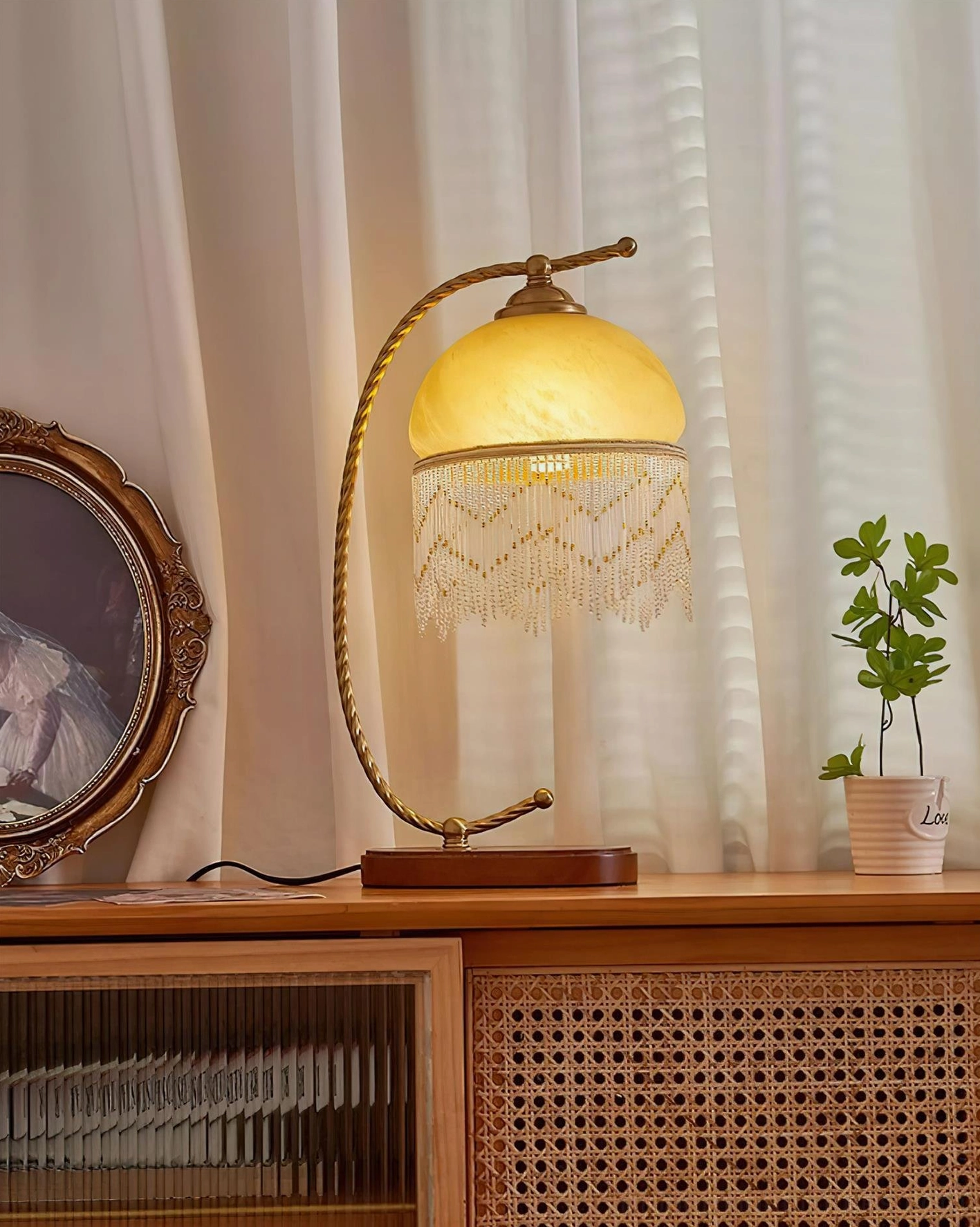 Roussillon Tassel Table Lamp bedside nightstand setting with soft ambient light vintage bedroom aesthetic