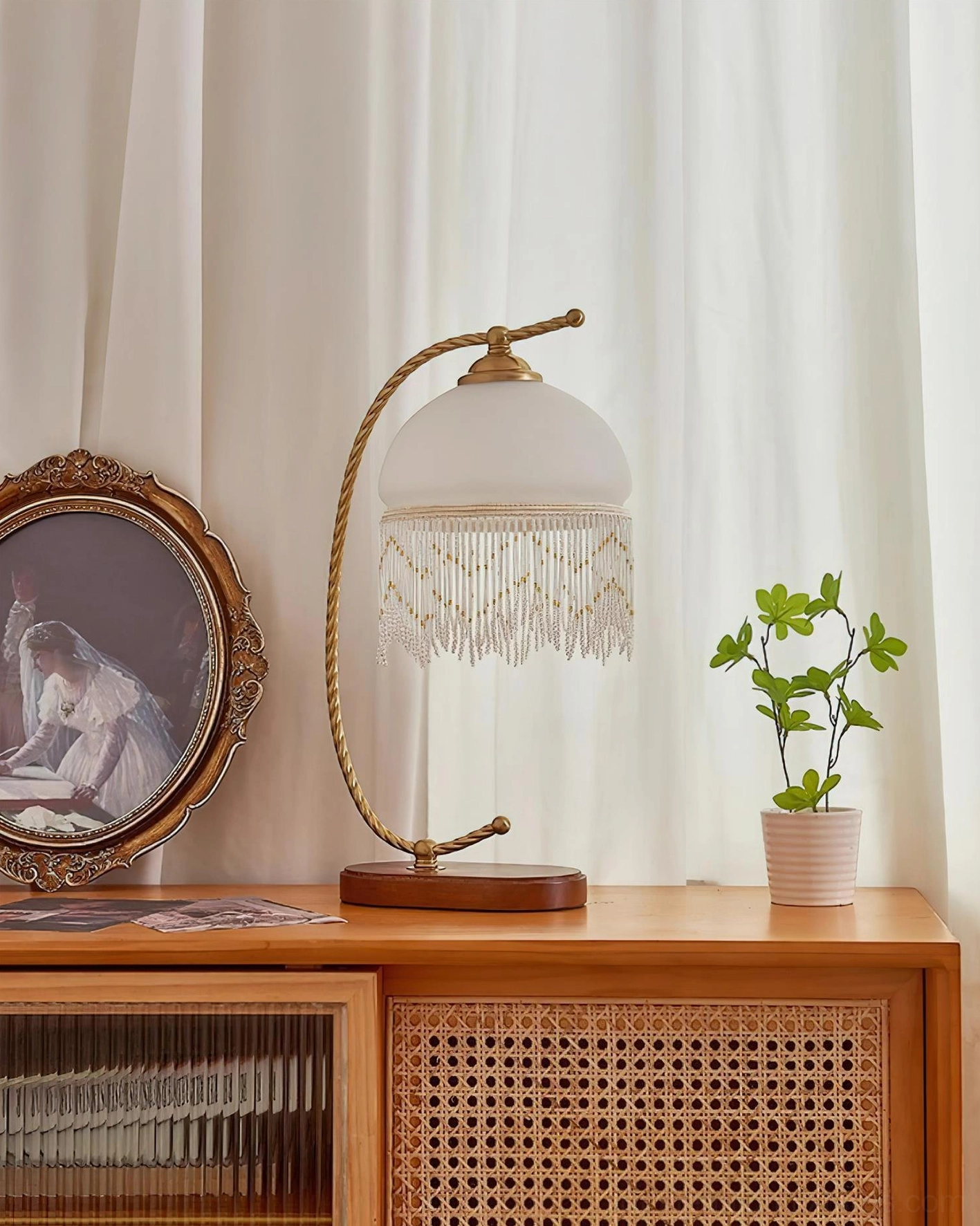 Roussillon Tassel Table Lamp white frosted glass shade three-quarter view wooden base brass arm beaded tassel detail