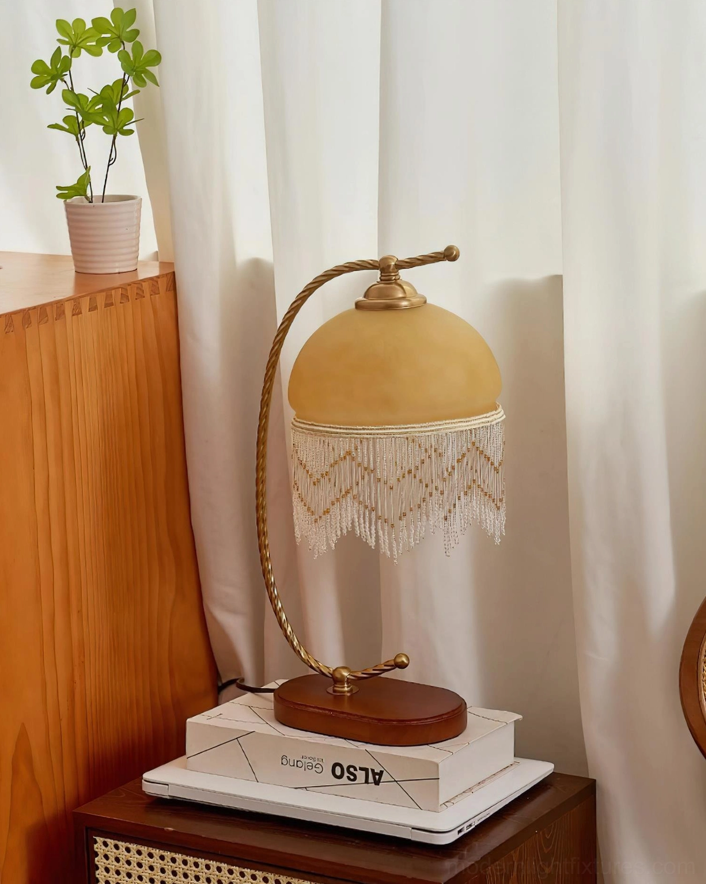 Roussillon Tassel Table Lamp yellow frosted glass shade curved brass arm wooden base three-quarter angle view