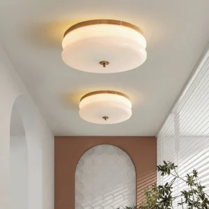 Pair of Rowen ceiling lights installed in residential hallway with arched wall decor, warm ambient lighting from flush mount fixtures