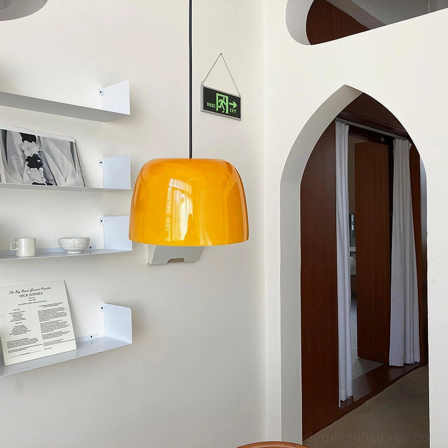 Roxboro modern amber pendant light in residential space with arched doorway architectural detail