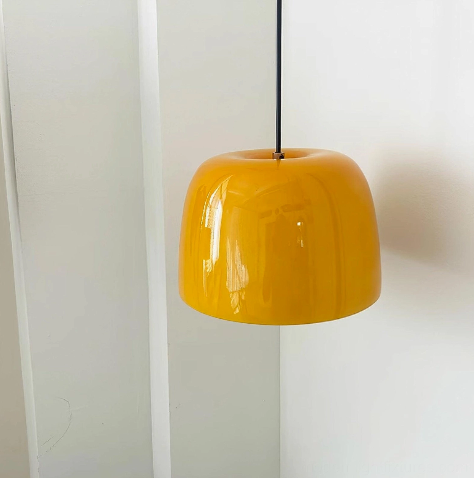 Roxboro amber pendant light fixture showing contemporary geometric form and warm glow characteristics