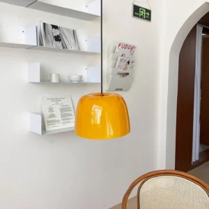 Roxboro amber pendant light in modern residential entryway with wall shelving and contemporary interior decor