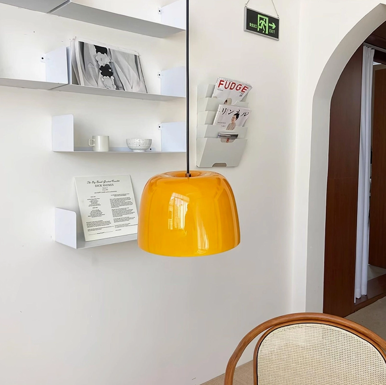 Roxboro amber pendant light in modern residential entryway with wall shelving and contemporary interior decor