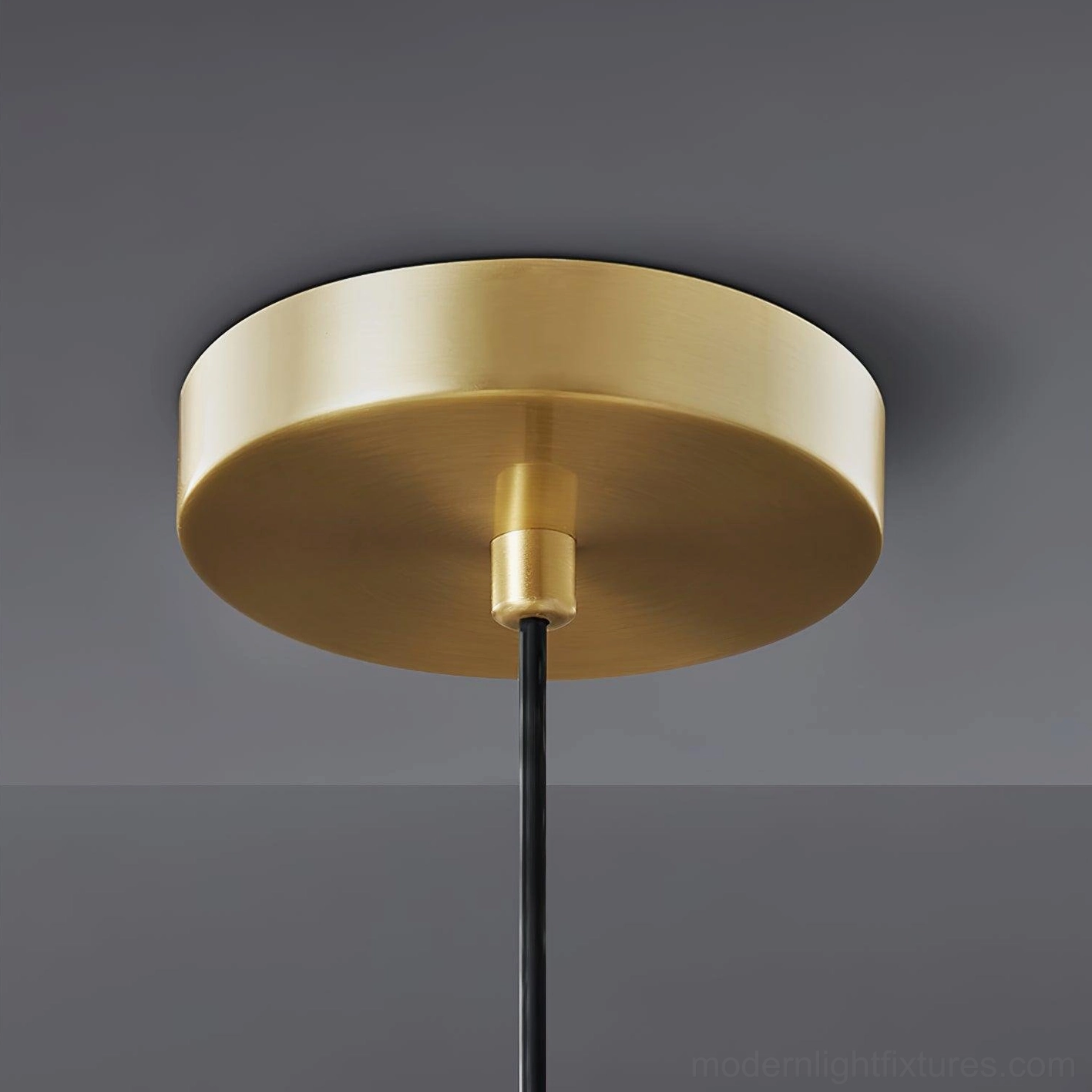Rozeta brass pendant light suspended in entryway creating focal point modern luxury home
