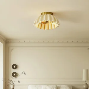 Overhead view of ruffle pleated ceiling light mounted in French country bedroom with warm neutral decor