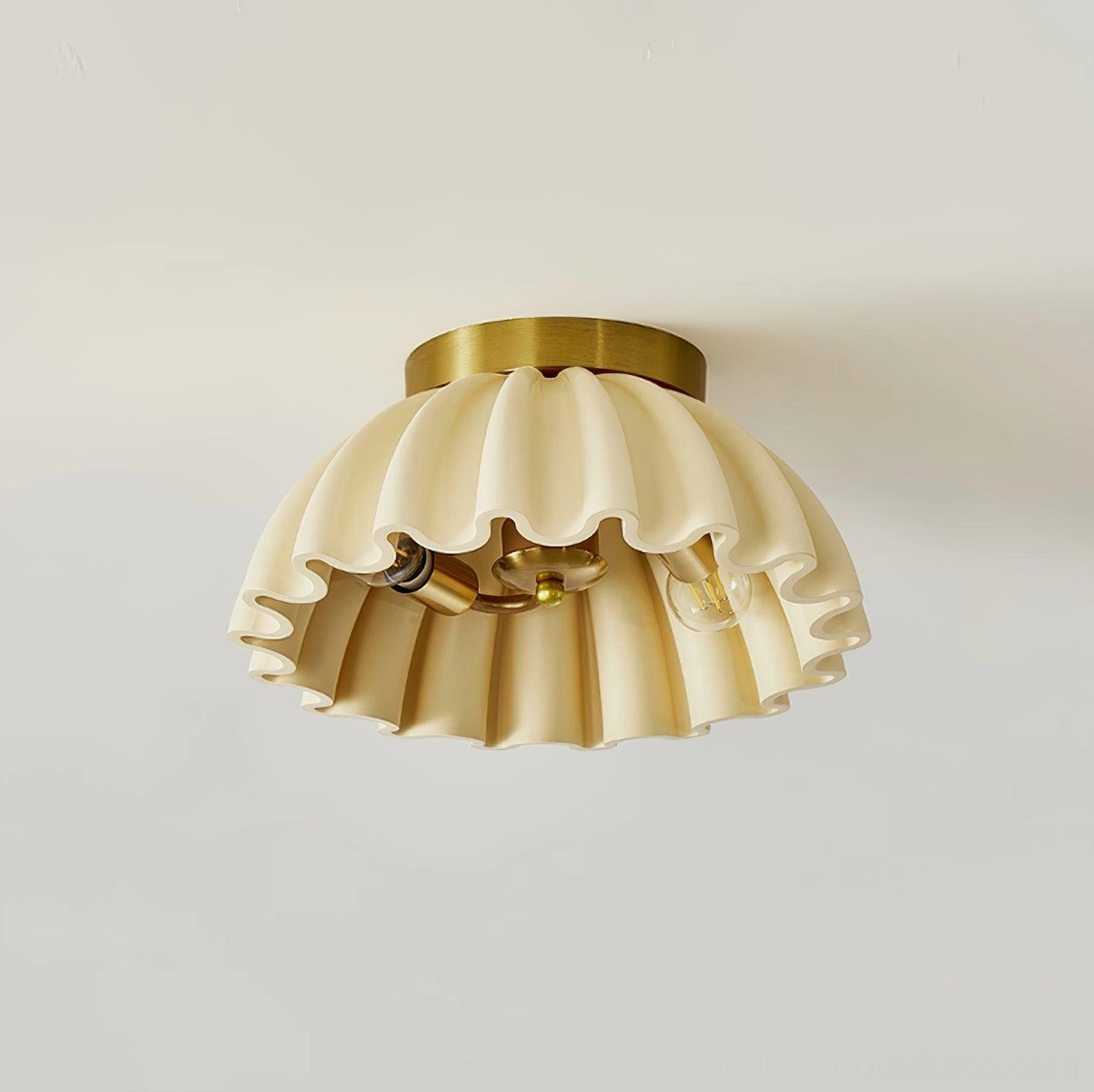 Low front angle of ruffle ceiling light showing exposed E14 socket brass hardware details