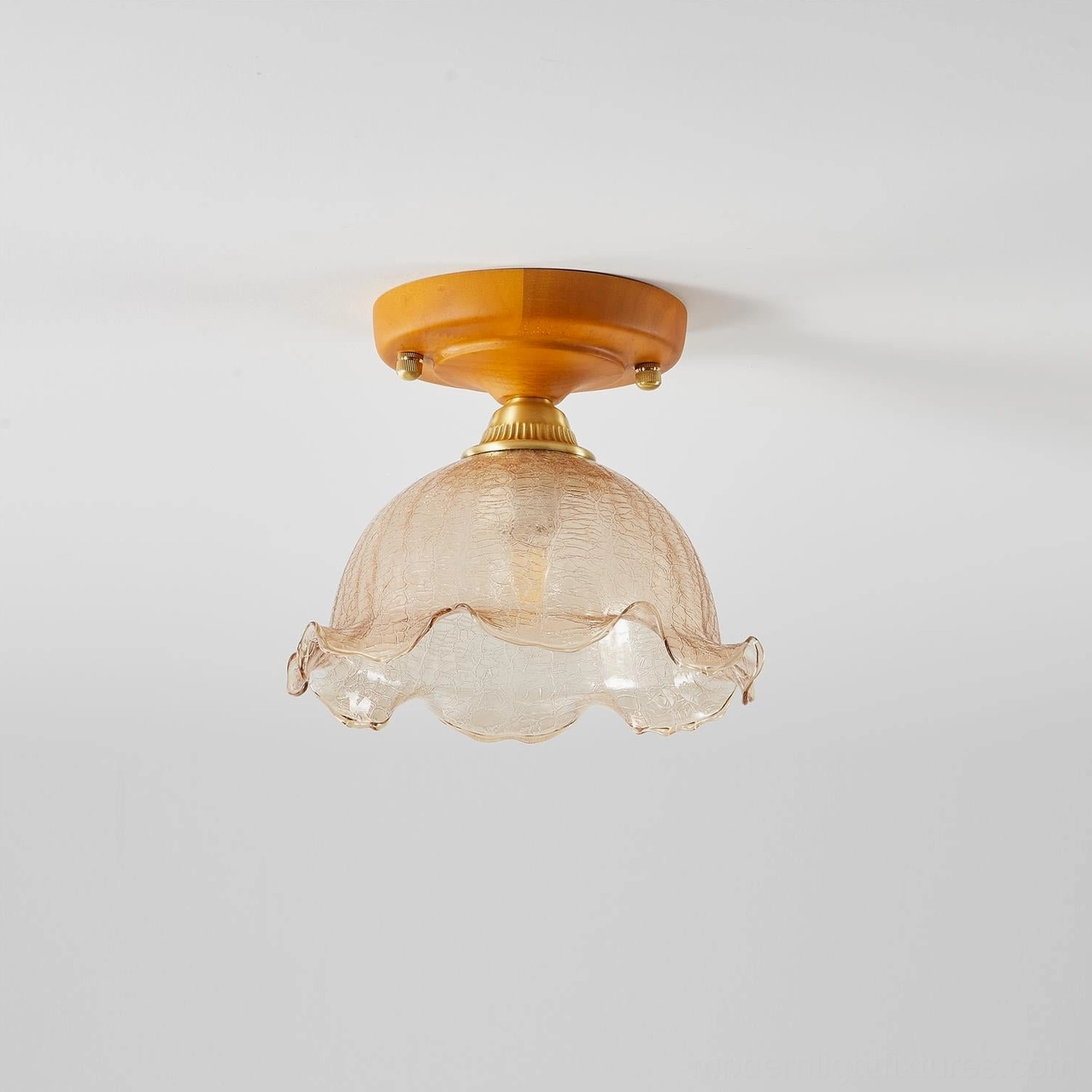 Ruffled dome vintage glass ceiling light with amber textured shade, brass fixture, studio white background