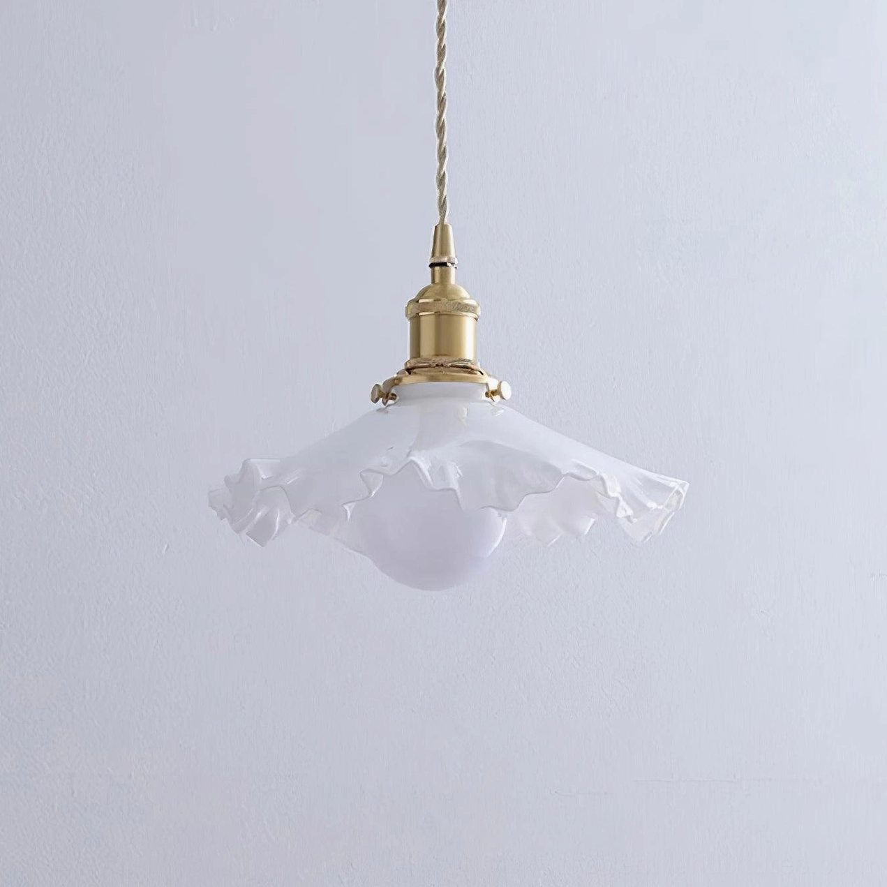 Ruffled glass pendant light with brass details, showcase view for modern lighting collections