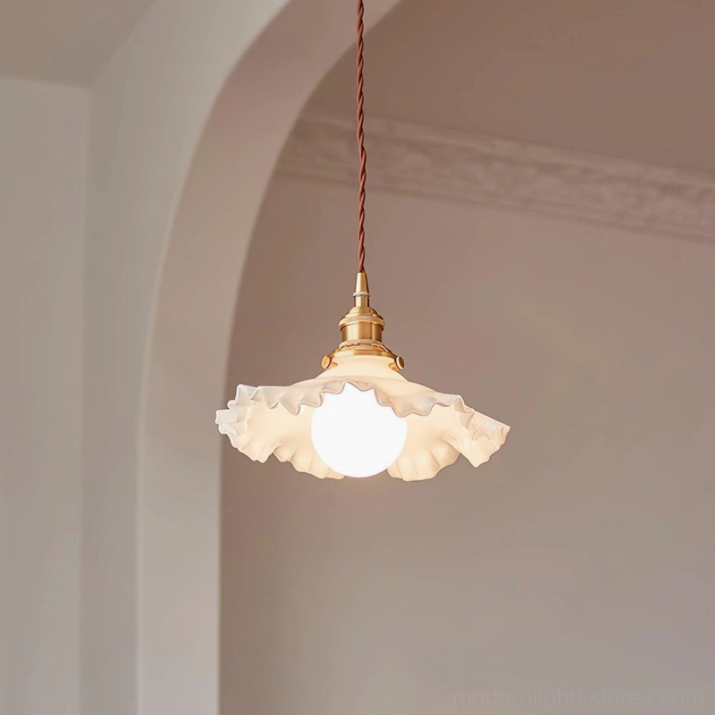 Ruffled glass pendant light showing sculptural shape and light diffusion quality in artistic product photography