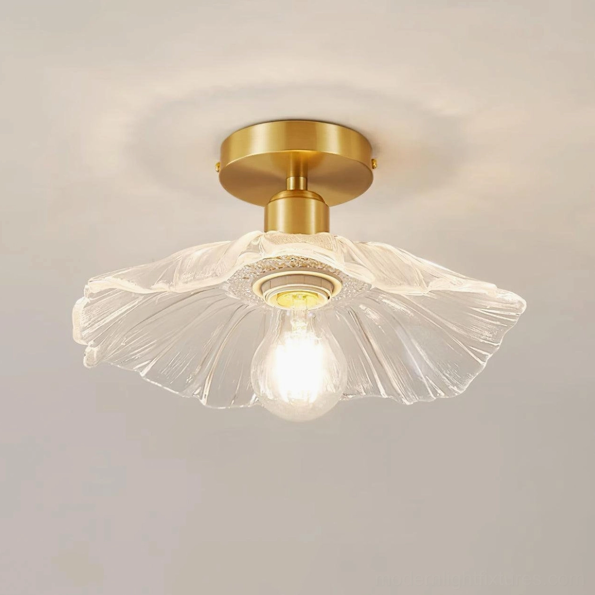 Ruffled glass semi-flush ceiling light fixture with brass canopy mounted in contemporary residential hallway