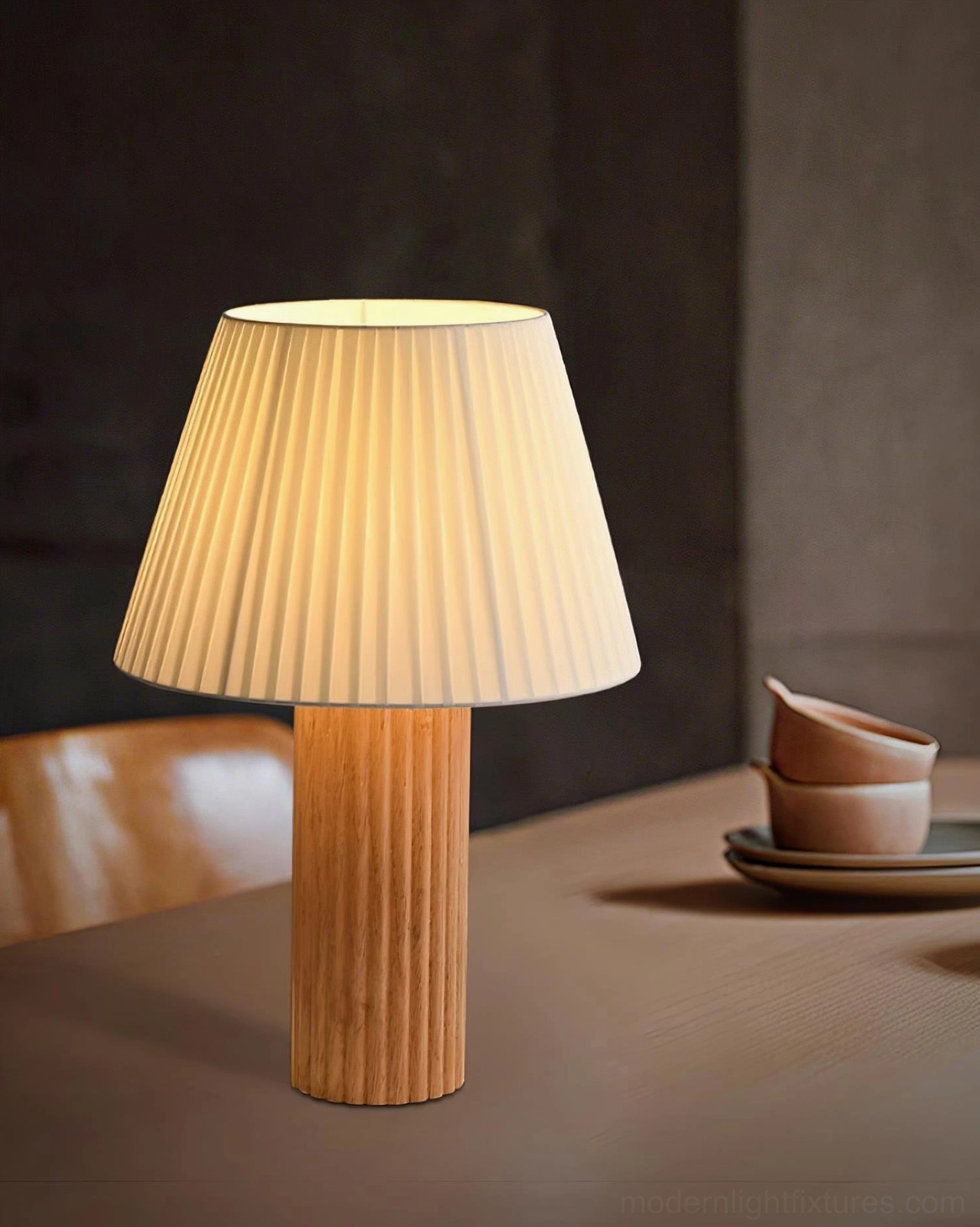 Rustic farmhouse style table lamp with natural wood base and pleated fabric shade creating warm ambient lighting in contemporary home interior