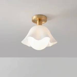Rustin semi-flush ceiling light fixture installed on white ceiling - overhead view of brass and white acrylic shade