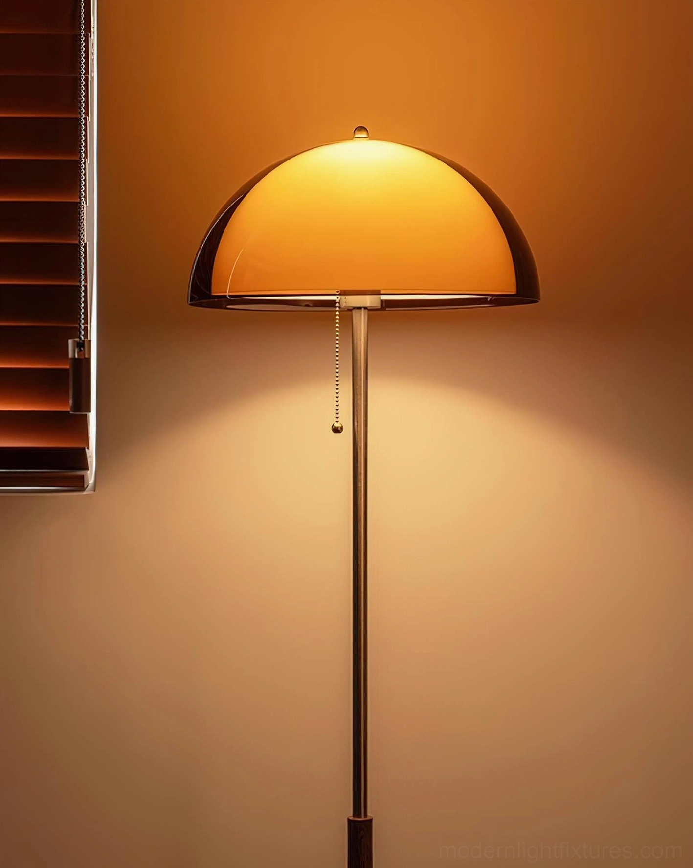 Lit Rustina amber floor lamp with pull-chain detail illuminated against indoor wall background, showcasing warm glowing ambiance