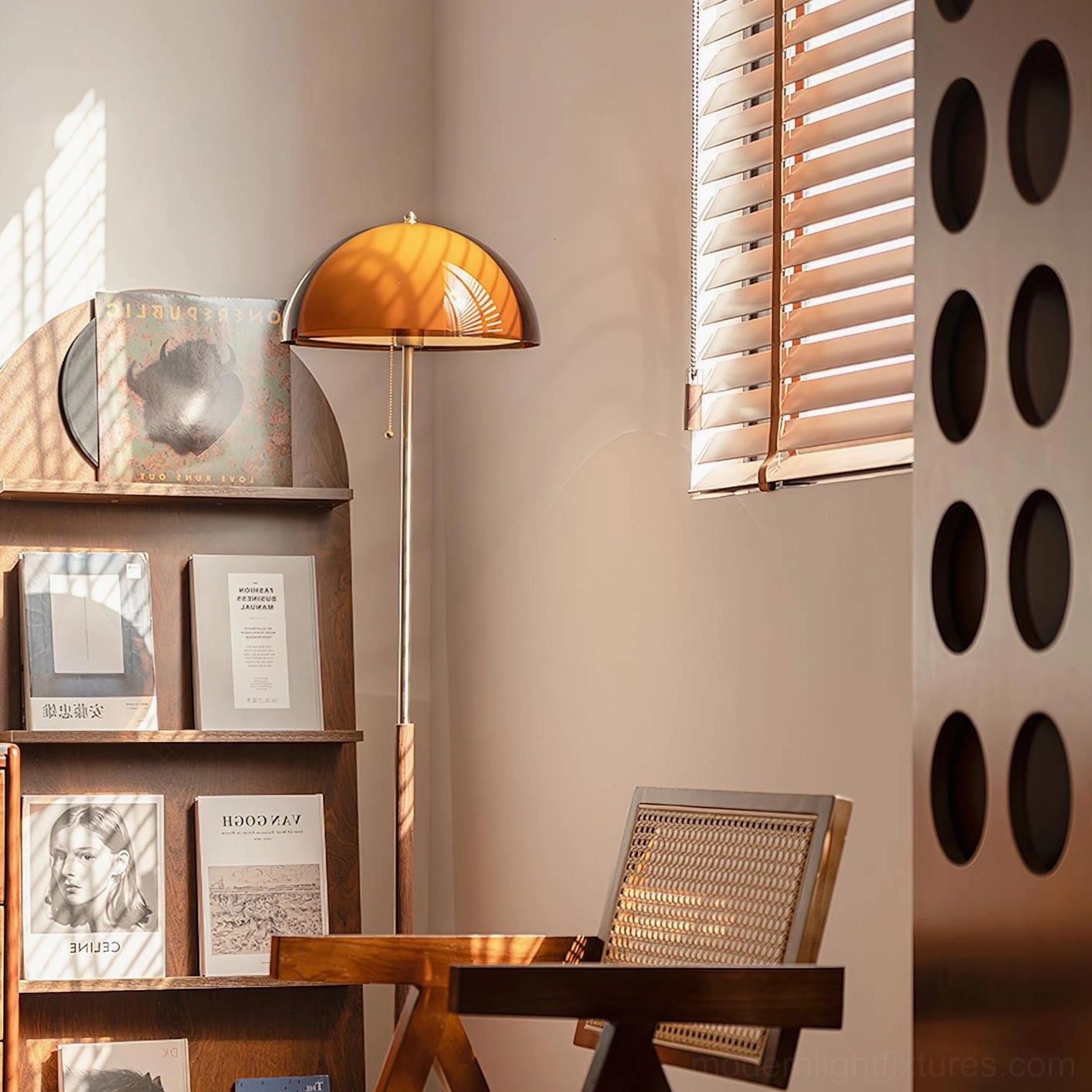 Amber dome floor lamp in cozy reading nook with bookshelf and rattan chair, low side angle displaying warm color temperature