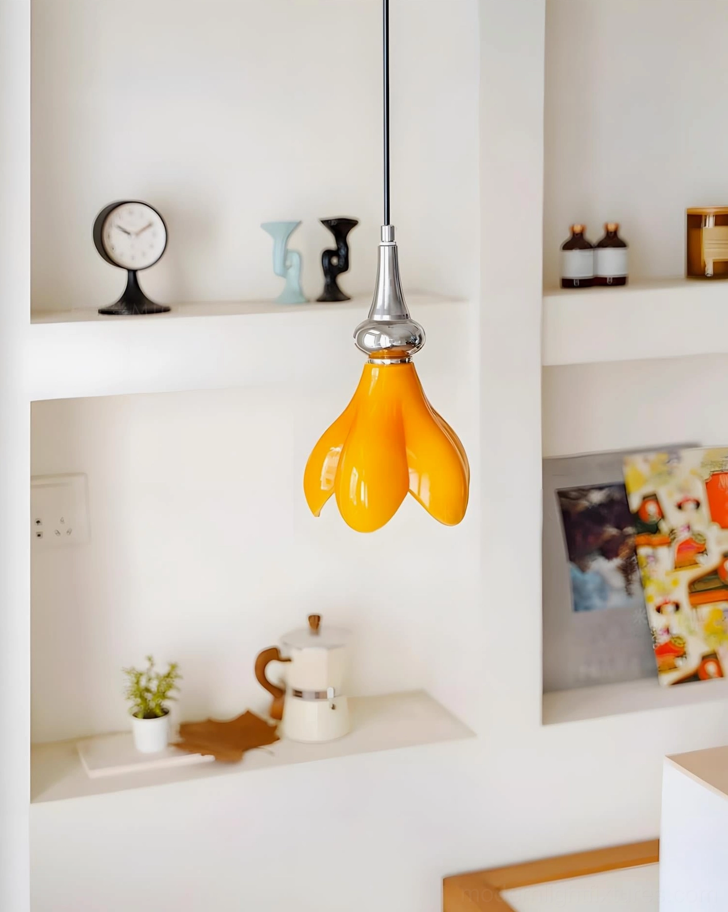 Saffron flower pendant light installed above decorative white shelf nook with modern minimalist wall shelving display